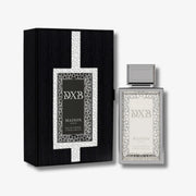 Maison DXB Paris Eau de Parfum bottle next to its black and silver presentation box, set against a clean white background.