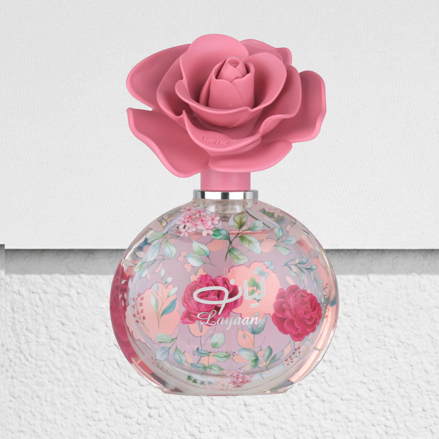Layaan has a Perfume bottle with pink rose design on a white background