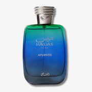 A bottle of Nawas Atlantis cologne for men, featuring a gradient blue and green glass bottle with a textured silver cap, set against a plain light gray background.