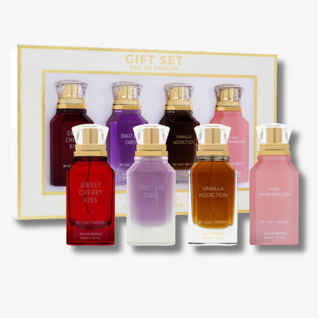 Set of six small perfume bottles in various colors with a gold cap, displayed in front of a gift box.