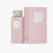A pink perfume bottle with a textured silver cap stands next to its matching pink box packaging, both featuring the brand name 'L’E Gemme ROSE' on a clean white background.