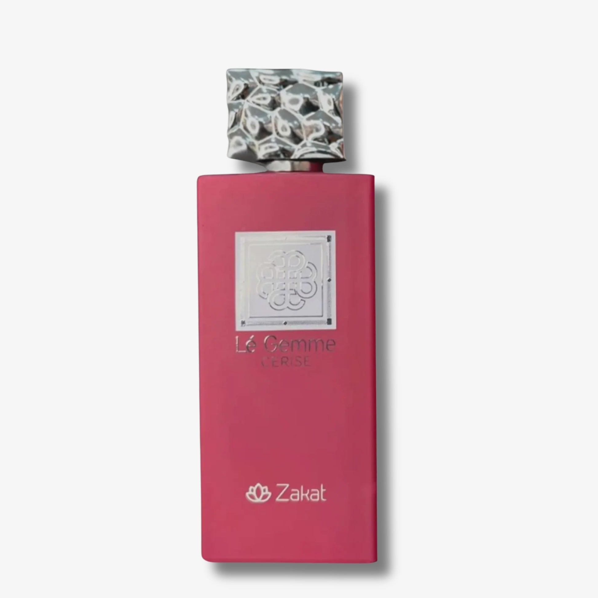 Zakat Le Gemme Paris perfume bottle with a vibrant pink rectangular body, a textured metallic cap, and a silver logo plaque on a light gray background.